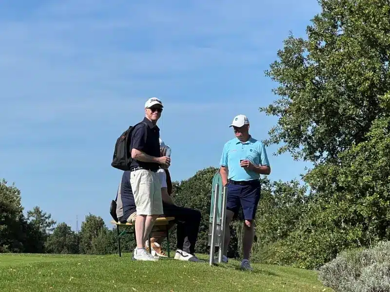 zwei Golfer unterhalten sich am Tee 1 / Grün 9